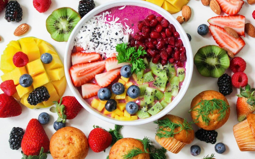 photo of assorted sliced fruits in a white ceramic bowl