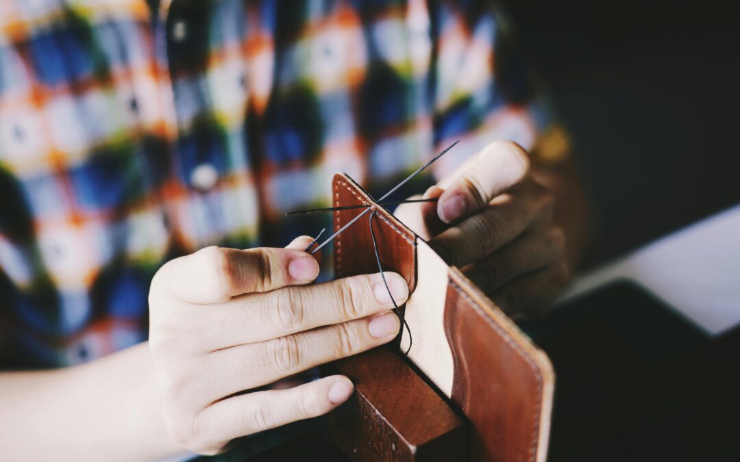 photo of a person knitting a brown leather textile