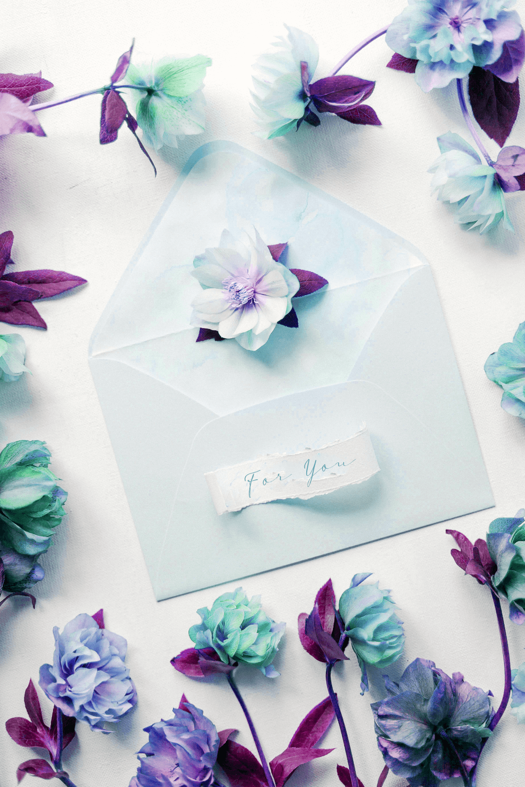 An envelope surrounded with flowers