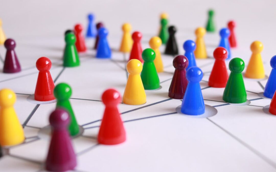 Multicolored game pegs sitting on a table and connected by black lines